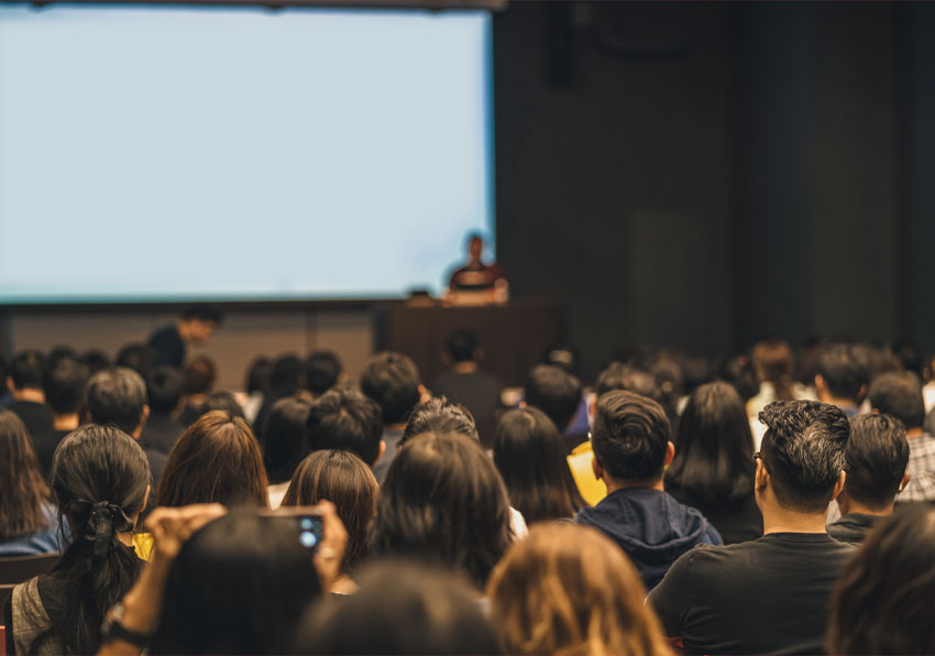 event image:Group of people attending to a conference.